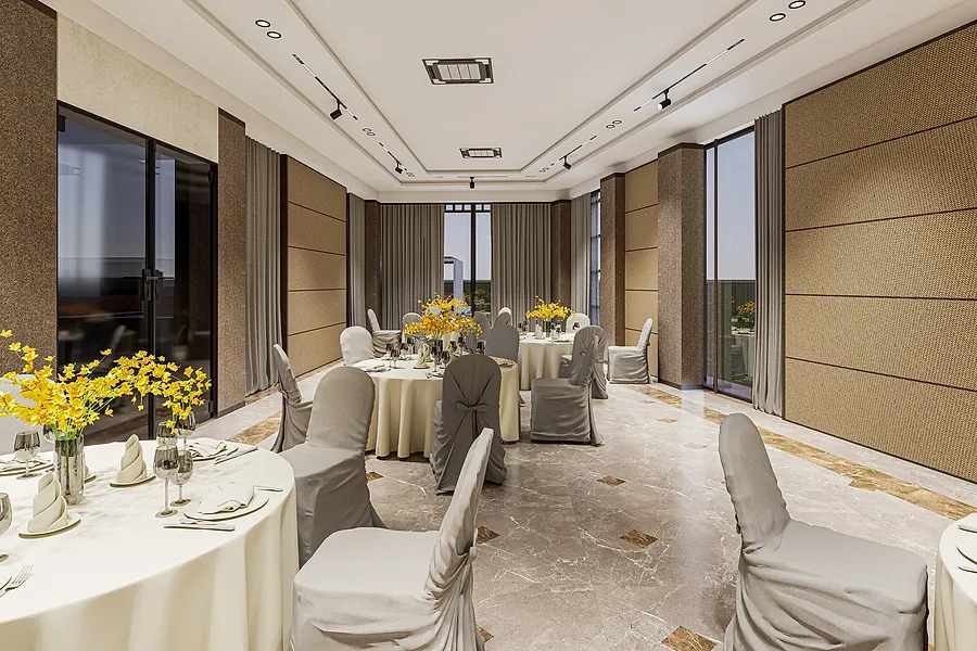 The banquet hall laid for a function, with round tables and full height glazing on two sides.