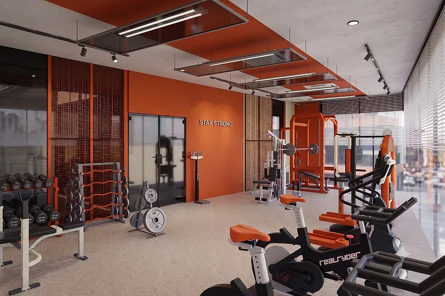 The gym: free weights, resistance machines and cardio bikes along a glazed wall.
