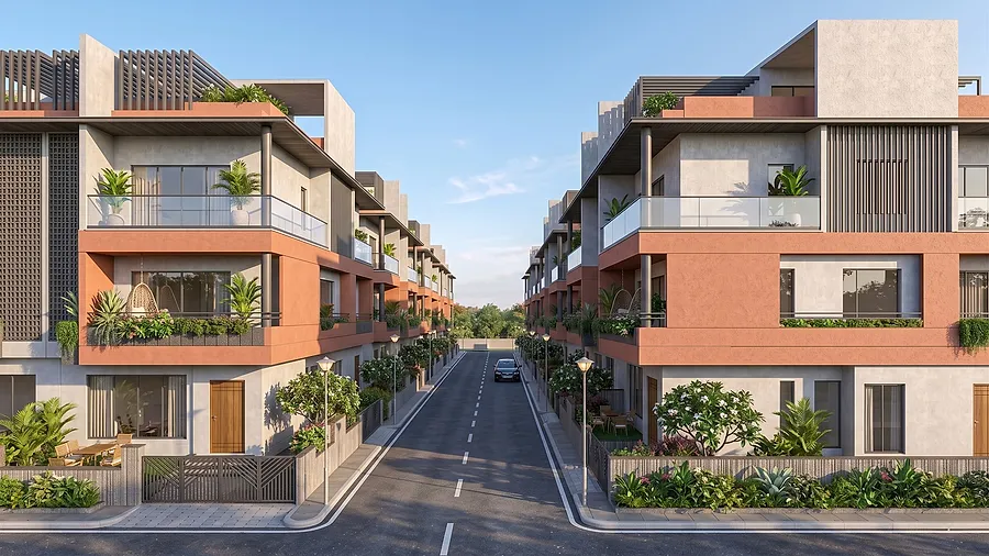 An internal street between two rows of villas, each with its own gate, planting and parking.